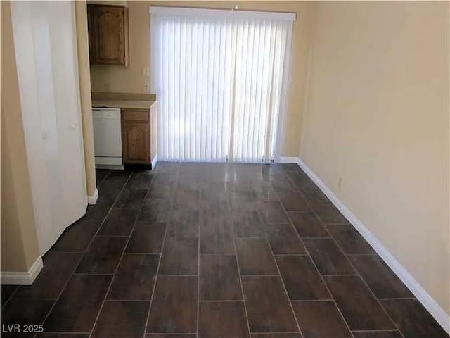 unfurnished dining area featuring baseboards