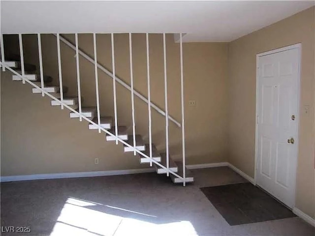 interior space with carpet flooring and baseboards