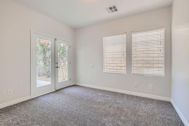 spare room with carpet flooring, baseboards, and french doors