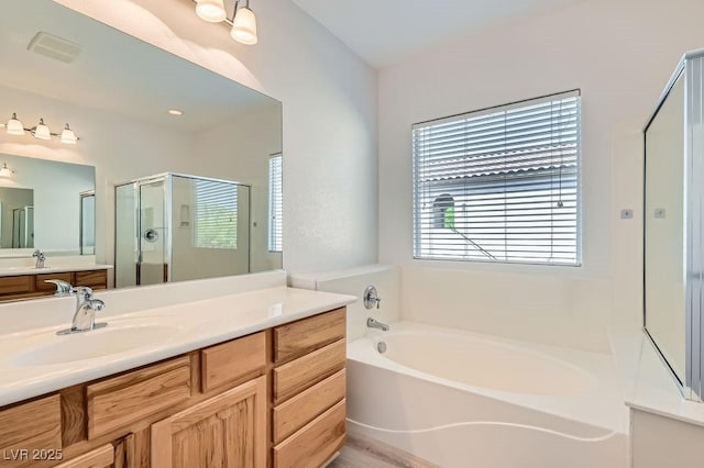 full bath with a shower stall, a garden tub, and vanity
