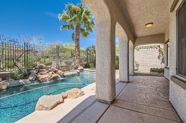 view of swimming pool with a fenced backyard, a patio, and a pool with connected hot tub