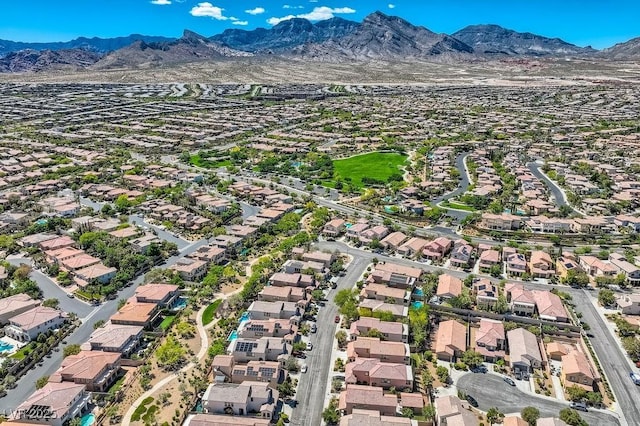 aerial overview of property's location with nearby suburban area and a mountain backdrop