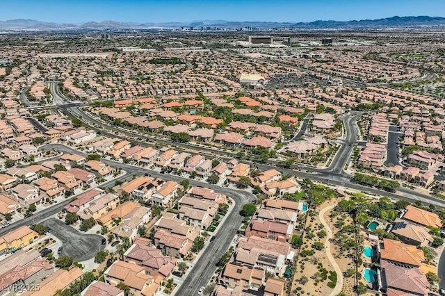 aerial view of property and surrounding area featuring mountains and nearby suburban area