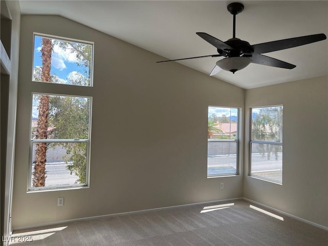 spare room featuring carpet flooring, baseboards, lofted ceiling, and ceiling fan