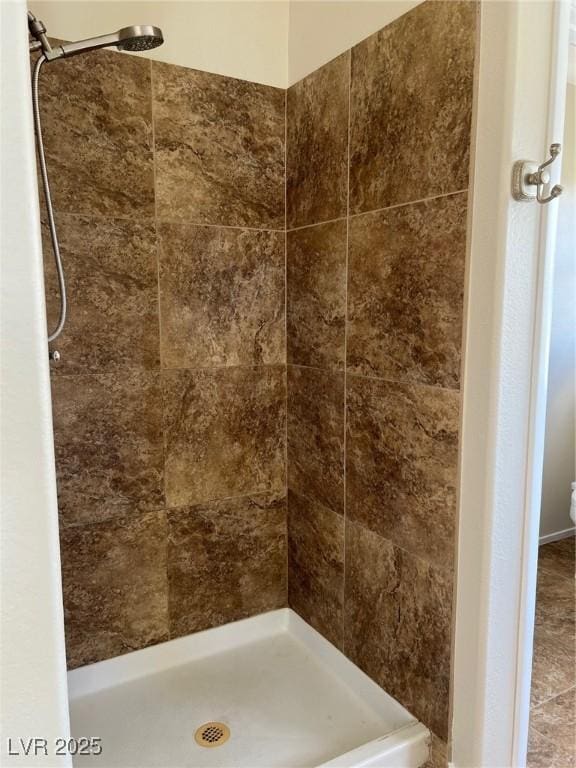 bathroom with tiled shower