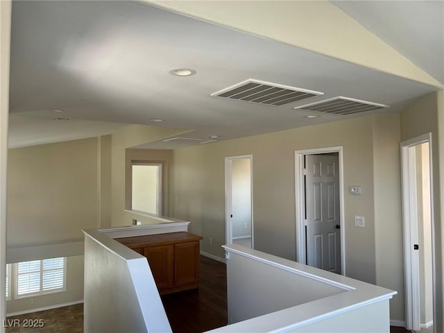 hallway featuring an upstairs landing, baseboards, visible vents, and recessed lighting