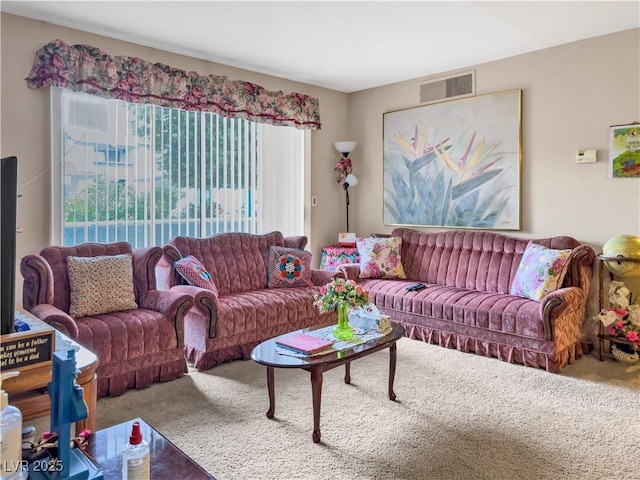 living room with visible vents and carpet floors