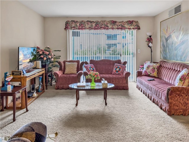 living area with visible vents and carpet floors