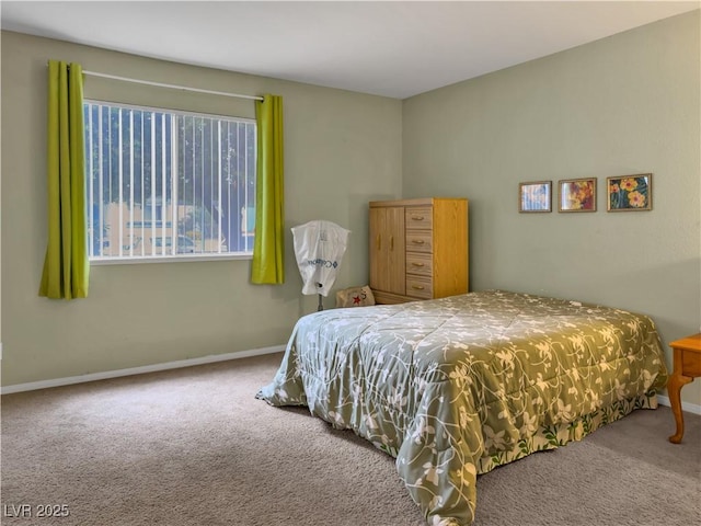 bedroom with carpet and baseboards