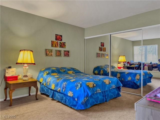 bedroom featuring carpet, a closet, and baseboards