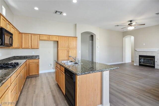 3278 Turning Bridge St, Las Vegas, NV 89135 - kitchen with a sink, arched walkways, black appliances, and visible vents