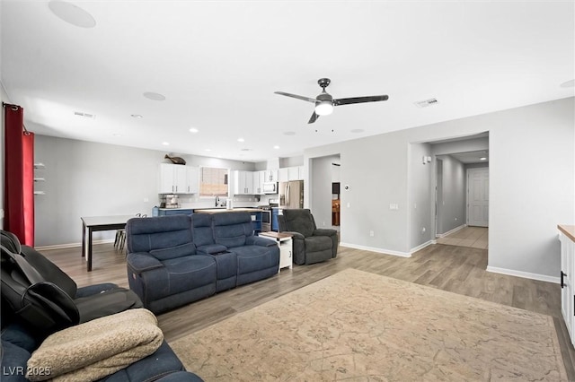 5631 Hill Cliff Ct, North Las Vegas, NV 89031 - living room featuring light wood-style flooring, baseboards, ceiling fan, and recessed lighting