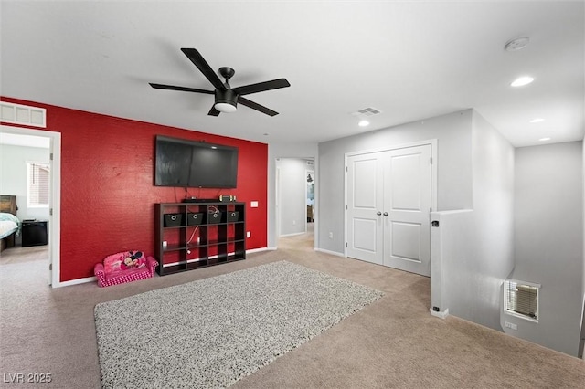 5631 Hill Cliff Ct, North Las Vegas, NV 89031 - carpeted living area featuring a ceiling fan, recessed lighting, and an accent wall