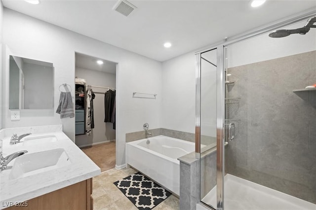 5631 Hill Cliff Ct, North Las Vegas, NV 89031 - full bath with a bath, a stall shower, double vanity, recessed lighting, and a spacious closet