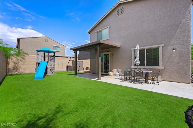 5631 Hill Cliff Ct, North Las Vegas, NV 89031 - back of property with stucco siding, a playground, and a patio area