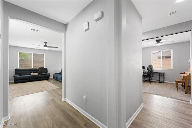 5631 Hill Cliff Ct, North Las Vegas, NV 89031 - hallway with an office area, wood finished floors, and baseboards