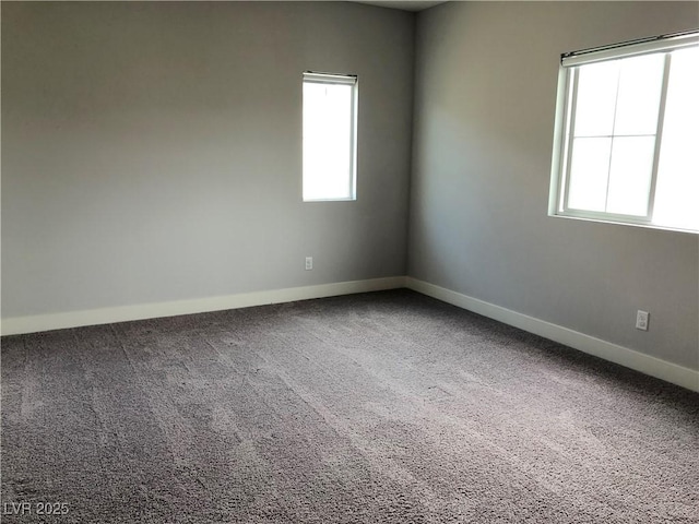 spare room with baseboards and carpet flooring