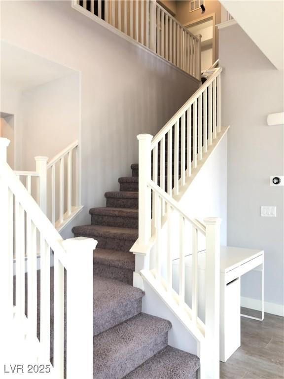 stairs featuring baseboards and wood finished floors