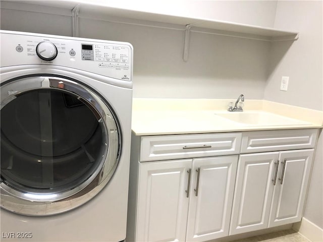 laundry area featuring washer / dryer, cabinet space, and a sink