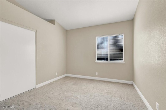 carpeted spare room with baseboards