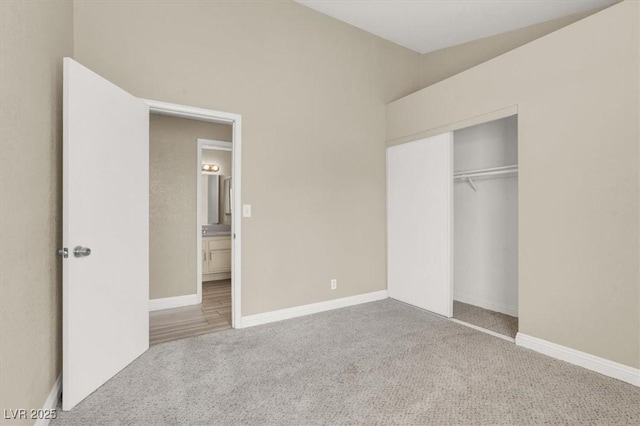unfurnished bedroom with baseboards, carpet flooring, and a closet