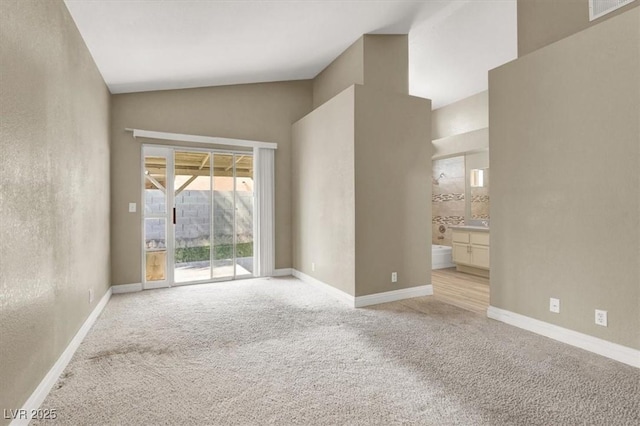 empty room with visible vents, baseboards, and light carpet