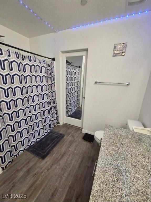 2872 Atomic Tangerine Way Unit 2, Las Vegas, NV 89183 - bathroom with vanity, wood finished floors, and a shower with shower curtain