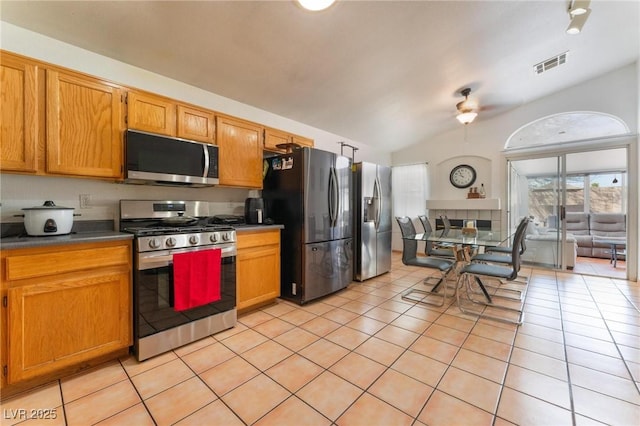 2903 Galena Peak Ln, Las Vegas, NV 89156 - kitchen featuring light tile patterned flooring, appliances with stainless steel finishes, lofted ceiling, and visible vents