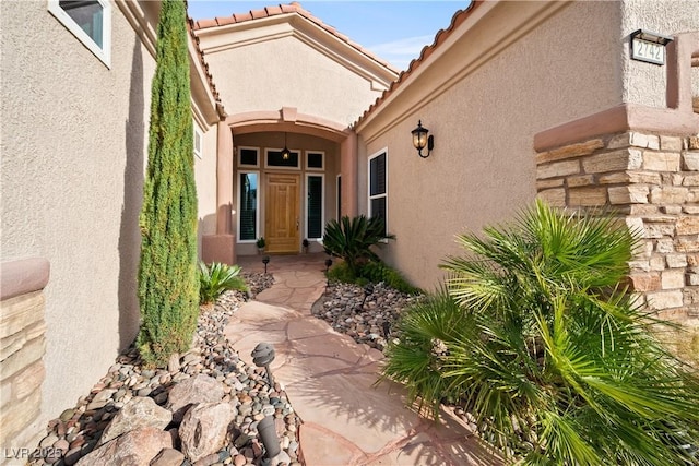 2742 Darby Falls Dr, Las Vegas, NV 89134 - doorway to property with stucco siding, a tiled roof, and stone siding