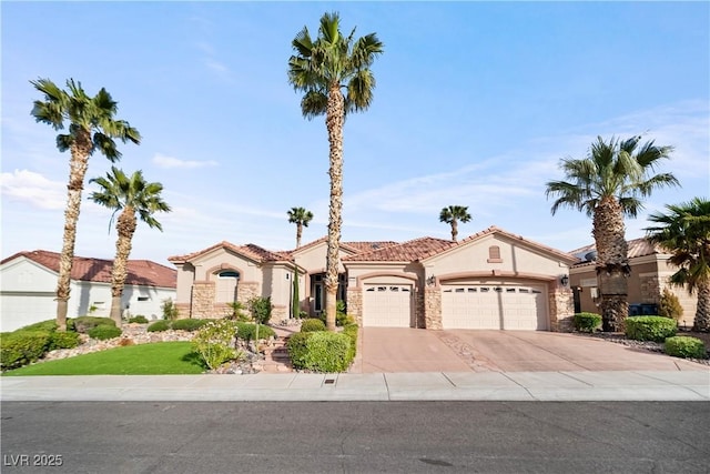 2742 Darby Falls Dr, Las Vegas, NV 89134 - mediterranean / spanish home with an attached garage, stucco siding, driveway, stone siding, and a tile roof