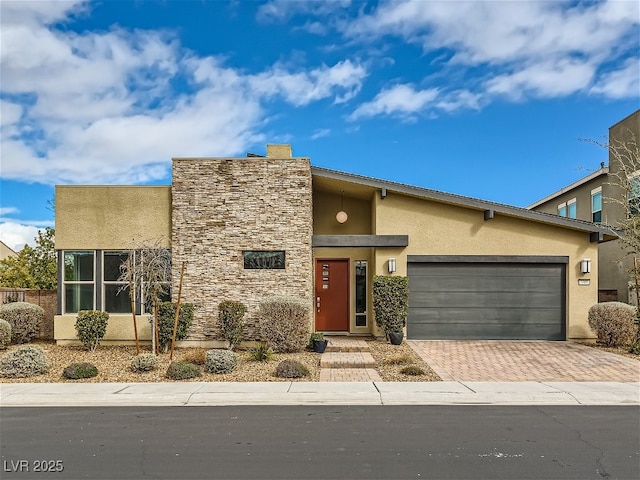3008 Barrett Springs Ave, Henderson, NV 89044 - view of front of house with a garage, stucco siding, decorative driveway, and stone siding
