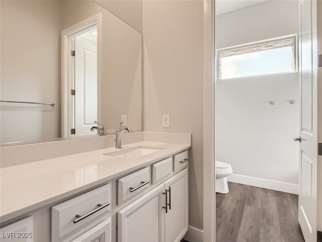 3008 Barrett Springs Ave, Henderson, NV 89044 - bathroom featuring vanity, baseboards, wood finished floors, and toilet