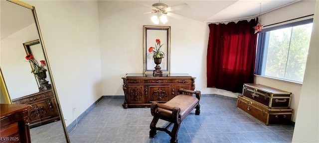 sitting room featuring tile patterned flooring, a ceiling fan, baseboards, and lofted ceiling