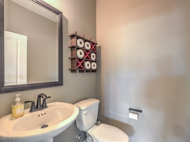 half bathroom with a sink and toilet