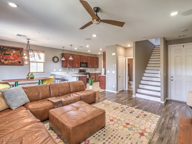 living room with ceiling fan, dark wood finished floors, stairs, recessed lighting, and visible vents