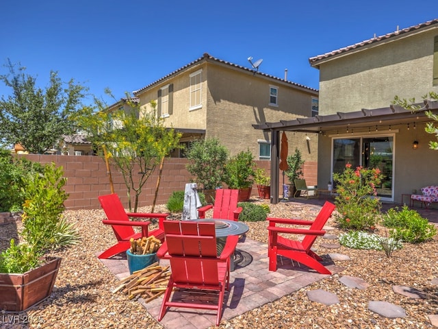 view of patio featuring fence and a fire pit