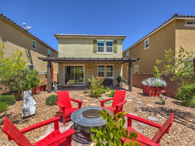 back of property with a patio, a fenced backyard, an outdoor fire pit, and stucco siding