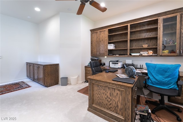 home office featuring baseboards, a ceiling fan, and light colored carpet