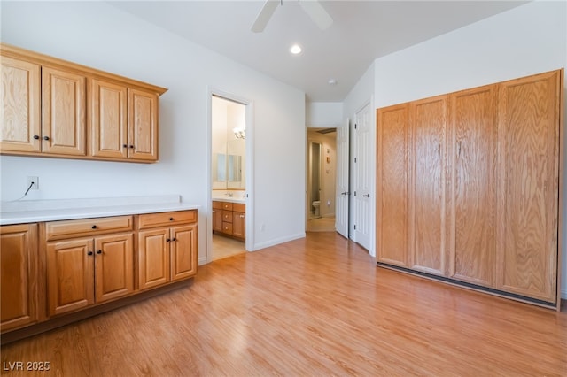 interior space with recessed lighting, baseboards, a ceiling fan, and light wood finished floors