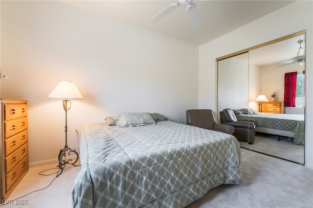 bedroom featuring baseboards, a ceiling fan, a closet, and light colored carpet