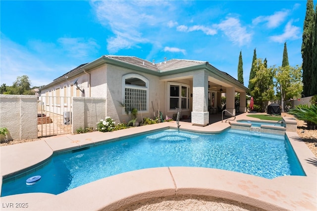 view of pool featuring fence private yard, ceiling fan, a patio area, and a pool with connected hot tub