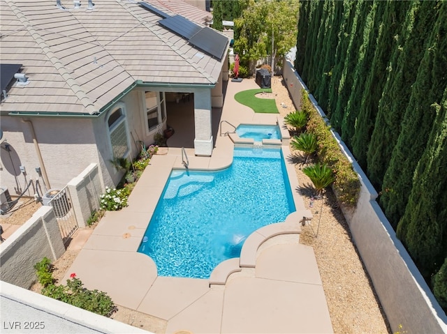 view of pool featuring a fenced backyard, a patio, and a pool with connected hot tub