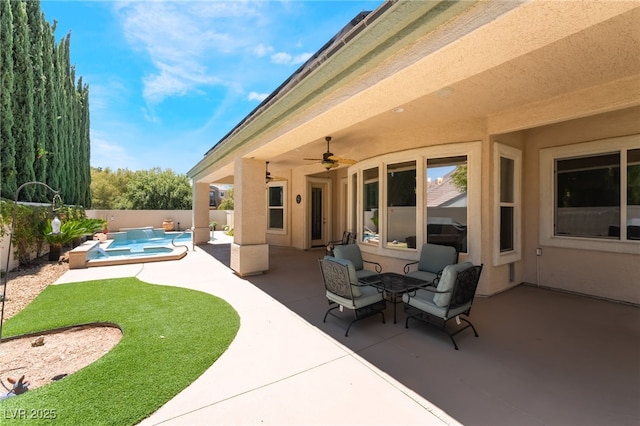 view of patio featuring a fenced in pool, a ceiling fan, a jacuzzi, and a fenced backyard