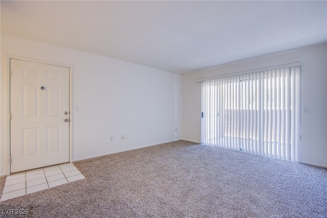 8070 W Russell Rd Unit 1028, Las Vegas, NV 89113 - unfurnished room with light colored carpet and light tile patterned flooring