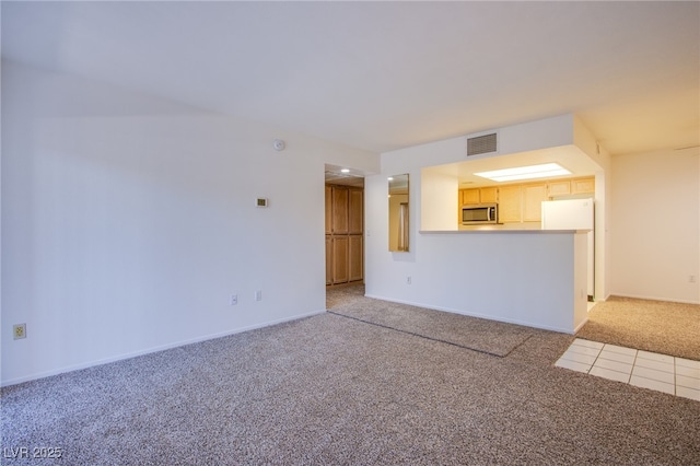 8070 W Russell Rd Unit 1028, Las Vegas, NV 89113 - unfurnished living room featuring light carpet and baseboards