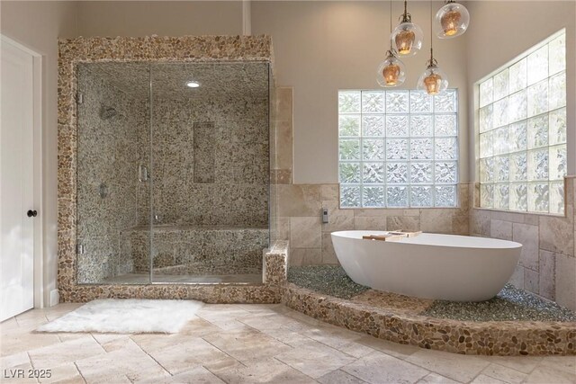 17 Grand Corniche Dr, Henderson, NV 89011 - bathroom featuring tile walls, a soaking tub, and a stall shower