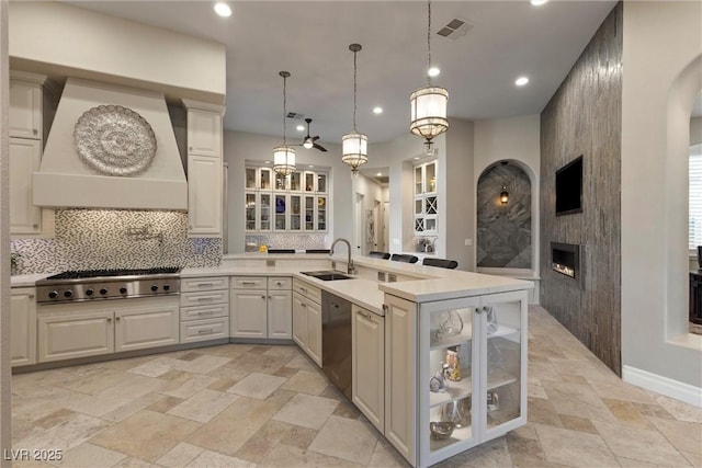17 Grand Corniche Dr, Henderson, NV 89011 - kitchen with visible vents, a large fireplace, tasteful backsplash, and stone tile flooring