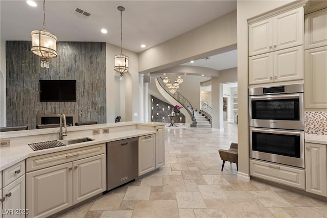 17 Grand Corniche Dr, Henderson, NV 89011 - kitchen with appliances with stainless steel finishes, a sink, stone tile floors, open floor plan, and visible vents