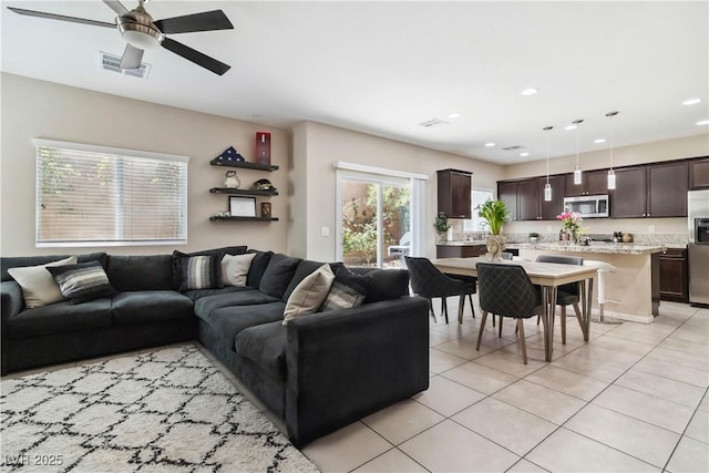 living room featuring ceiling fan, light tile patterned flooring, and recessed lighting