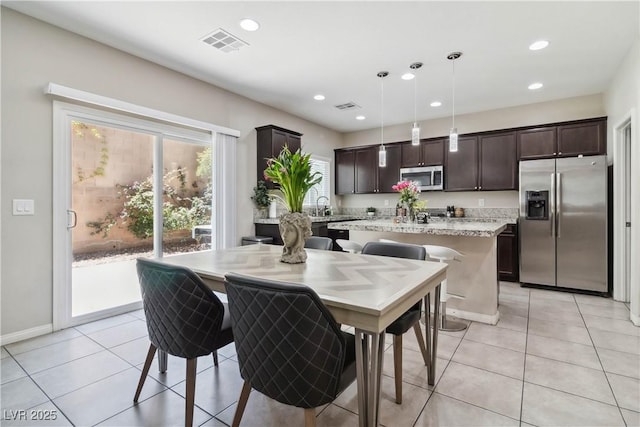 dining area featuring recessed lighting, light tile patterned floors, and baseboards